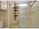 Large walk in shower with shelving and a sliding glass door at 6308 Bayberry Ne Blvd, Winter Haven, FL 33881