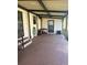 Covered back patio with a concrete floor and storage space at 6447 Hollyberry Ne Ln, Winter Haven, FL 33881