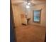 Bright bedroom with wood-paneled walls and carpeted floors at 6447 Hollyberry Ne Ln, Winter Haven, FL 33881