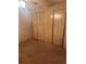 Bedroom with wood paneling walls, wall-to-wall carpeting, and ample closet space at 6447 Hollyberry Ne Ln, Winter Haven, FL 33881