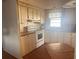 Kitchen with white cabinets, wood-look flooring, and built-in appliances at 6447 Hollyberry Ne Ln, Winter Haven, FL 33881
