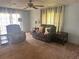Living room with comfy seating, end tables, and carpeted floors at 6447 Hollyberry Ne Ln, Winter Haven, FL 33881