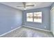 Bedroom with tile floors, window, and ceiling fan at 710 Highlands Ave, Dundee, FL 33838