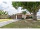 Cute one-story home with a large tree and driveway at 81 Tyler Rd, Winter Haven, FL 33884