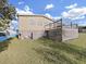 Rear view of tan mobile home with deck and AC unit at 1750 Fox Hill Dr, Lakeland, FL 33810