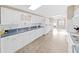 White kitchen features ample cabinetry and a view into the adjacent dining area at 1750 Fox Hill Dr, Lakeland, FL 33810