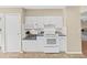 White kitchen features microwave, stovetop and ample counter space at 1750 Fox Hill Dr, Lakeland, FL 33810