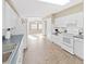 White kitchen with blue countertops and tile flooring, open to dining area at 1750 Fox Hill Dr, Lakeland, FL 33810