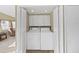 Bright laundry closet with washer and dryer, and built in shelving at 1750 Fox Hill Dr, Lakeland, FL 33810