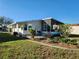 Charming single-wide home with a screened porch at 418 Village Sw Cir, Winter Haven, FL 33880