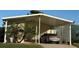 Mobile home with carport and landscaped yard at 418 Village Sw Cir, Winter Haven, FL 33880