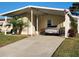 Mobile home with carport, landscaping, and driveway at 418 Village Sw Cir, Winter Haven, FL 33880