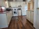 Bright kitchen with white cabinets and laminate flooring at 418 Village Sw Cir, Winter Haven, FL 33880