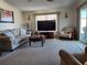 Spacious living room with large TV and comfortable seating at 418 Village Sw Cir, Winter Haven, FL 33880