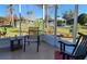 Screened porch with lake and community pool view at 418 Village Sw Cir, Winter Haven, FL 33880