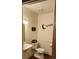 Small bathroom with a toilet, sink, and decorative wall art at 1190 S Goodman Rd, Champions Gate, FL 33896