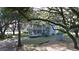 Two story house with a carport and a large oak tree in the front at 1190 S Goodman Rd, Champions Gate, FL 33896