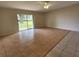 Living room featuring tile floors and access to backyard at 609 Estrada Ln, Kissimmee, FL 34758