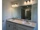 Double vanity bathroom with modern fixtures and a large mirror at 1049 Bergamot Dr, Bartow, FL 33830