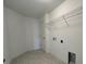 Laundry room with built-in shelving and tile flooring at 1049 Bergamot Dr, Bartow, FL 33830