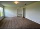 Spacious bedroom with neutral carpeting and access to another room at 1049 Bergamot Dr, Bartow, FL 33830