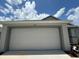 White two-car garage with a clean and modern look at 1049 Bergamot Dr, Bartow, FL 33830