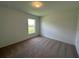 Bright bedroom featuring neutral walls and carpeted floors at 1049 Bergamot Dr, Bartow, FL 33830