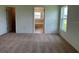 Bright bedroom with plush carpeting, an ensuite bathroom, and a large window at 1049 Bergamot Dr, Bartow, FL 33830