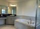 Bathroom with a soaking tub, walk-in shower, and vanity at 1218 Navel Rd, Bartow, FL 33830