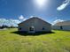 Rear view of house with grassy yard at 1061 Bergamot Dr, Bartow, FL 33830