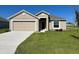 One-story home with a two-car garage and well-maintained lawn at 1061 Bergamot Dr, Bartow, FL 33830
