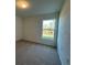 Spacious bedroom with carpeted floors and a large window with wooded views at 2169 Emma Ln, Lake Wales, FL 33859