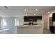 Modern kitchen featuring dark cabinets, an island, and stainless steel appliances at 2169 Emma Ln, Lake Wales, FL 33859