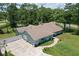 Aerial view showcasing a single-story house, a spacious yard, and a unique driveway at 213 Riverbend Rd, Ormond Beach, FL 32174