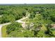 Aerial view showing home's location in a quiet, wooded neighborhood at 213 Riverbend Rd, Ormond Beach, FL 32174