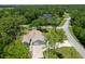 An aerial view of a house nestled in a wooded neighborhood, showcasing its curb appeal at 213 Riverbend Rd, Ormond Beach, FL 32174