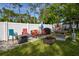 Relaxing backyard patio with fire pit, seating, and grill at 213 Riverbend Rd, Ormond Beach, FL 32174