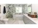 Spa-like bathroom featuring a soaking tub, double vanity, and marble floors at 213 Riverbend Rd, Ormond Beach, FL 32174