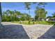 Brick paved driveway leading to a house, surrounded by mature trees and lush greenery at 213 Riverbend Rd, Ormond Beach, FL 32174