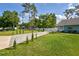 House exterior and driveway with neatly landscaped lawn and trees in the background at 213 Riverbend Rd, Ormond Beach, FL 32174