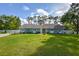 Front yard view of the house, showcasing the lawn and landscaping at 213 Riverbend Rd, Ormond Beach, FL 32174