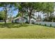 Side view of the home, showcasing its light blue color and landscaping at 213 Riverbend Rd, Ormond Beach, FL 32174