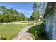 Landscaped front yard with a walkway leading to the entrance at 213 Riverbend Rd, Ormond Beach, FL 32174