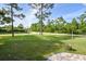 Landscaped front yard with a brick walkway and mature trees at 213 Riverbend Rd, Ormond Beach, FL 32174