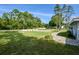 Neat front yard with a curved walkway and lush landscaping at 213 Riverbend Rd, Ormond Beach, FL 32174