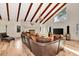 Open living area featuring hardwood floors, a fireplace, and a large sectional sofa at 213 Riverbend Rd, Ormond Beach, FL 32174