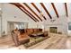 Living room with hardwood floors, fireplace, and sectional sofa under high ceilings at 213 Riverbend Rd, Ormond Beach, FL 32174