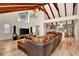 Spacious living room with hardwood floors, exposed beams, and a cozy sectional sofa at 213 Riverbend Rd, Ormond Beach, FL 32174