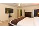 Main bedroom with king-size bed and a large TV at 213 Riverbend Rd, Ormond Beach, FL 32174