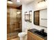 Updated bathroom features a walk-in shower, modern vanity, and stylish fixtures at 210 W Illiana St, Orlando, FL 32806